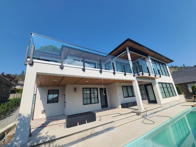 Modern home with glass balcony railing